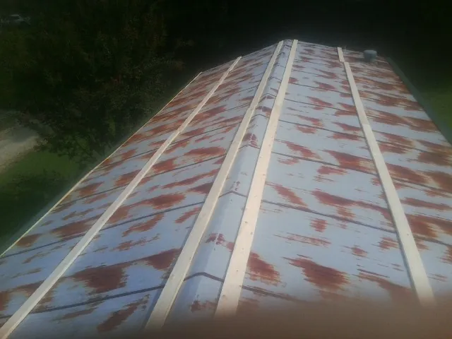 Rusted metal roof panels with new wood purlins before replacement — Storm Damage Roof Repair in West Shokan by Roofing Brothers