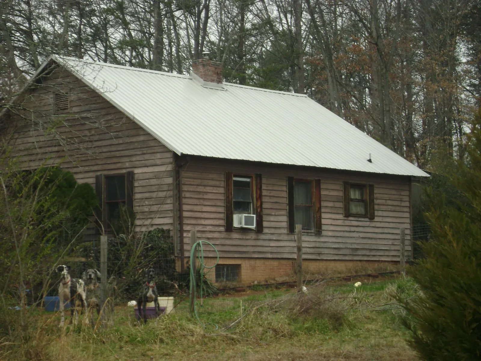 White metal roof on an old wood sided farmhouse, from a Metal Roof Installation job in West Shokan
